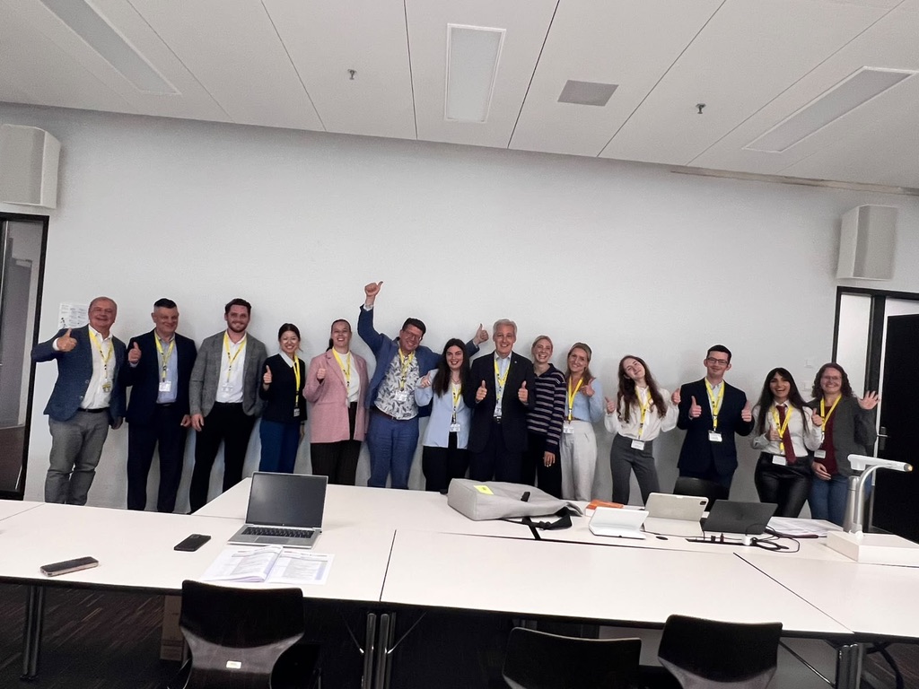 Members of the ISPC 2026 conference community standing together after a session